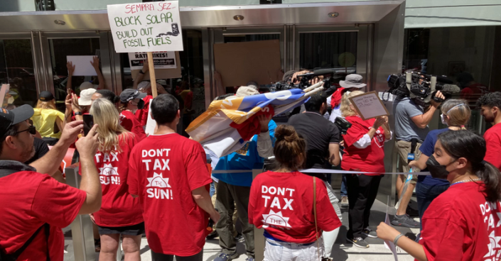 Solar industry supporters rallied outside of Sempra’s San Diego headquarters complaining about making rooftop solar much more expensive.