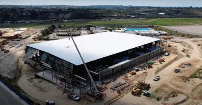 The new 7,500 capacity venue, Frontwave Arena, partners with Baker Electric for a renewable energy project, featuring solar array and storage